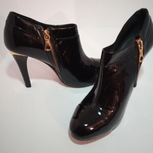 BCBGMaxAzria Patent Black Boots Ankle Booties. NWT. Gold metal heel. Size 5 1/2B